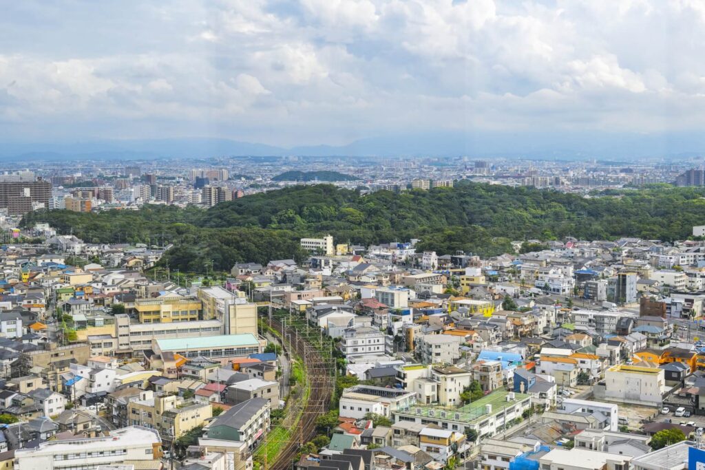 堺市の街並みを上空から俯瞰で撮影した、家族葬や葬儀エリアの広がりが伝わる空撮イメージ画像。